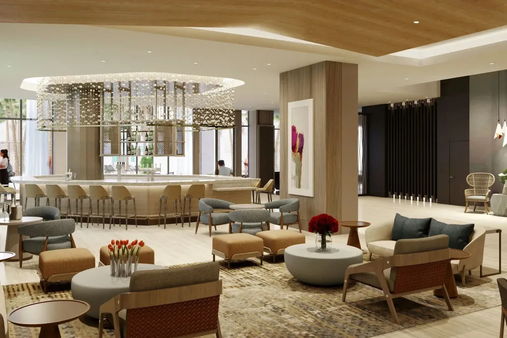 Un espace de détente intérieur avec des fauteuils et un bar en arrière-plan.