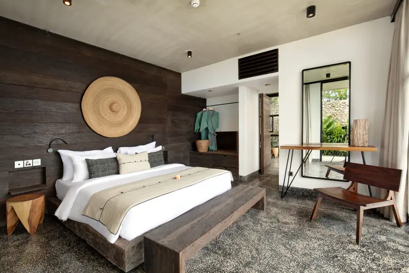 Une chambre à coucher lumineuse avec un grand lit et une décoration en bois.