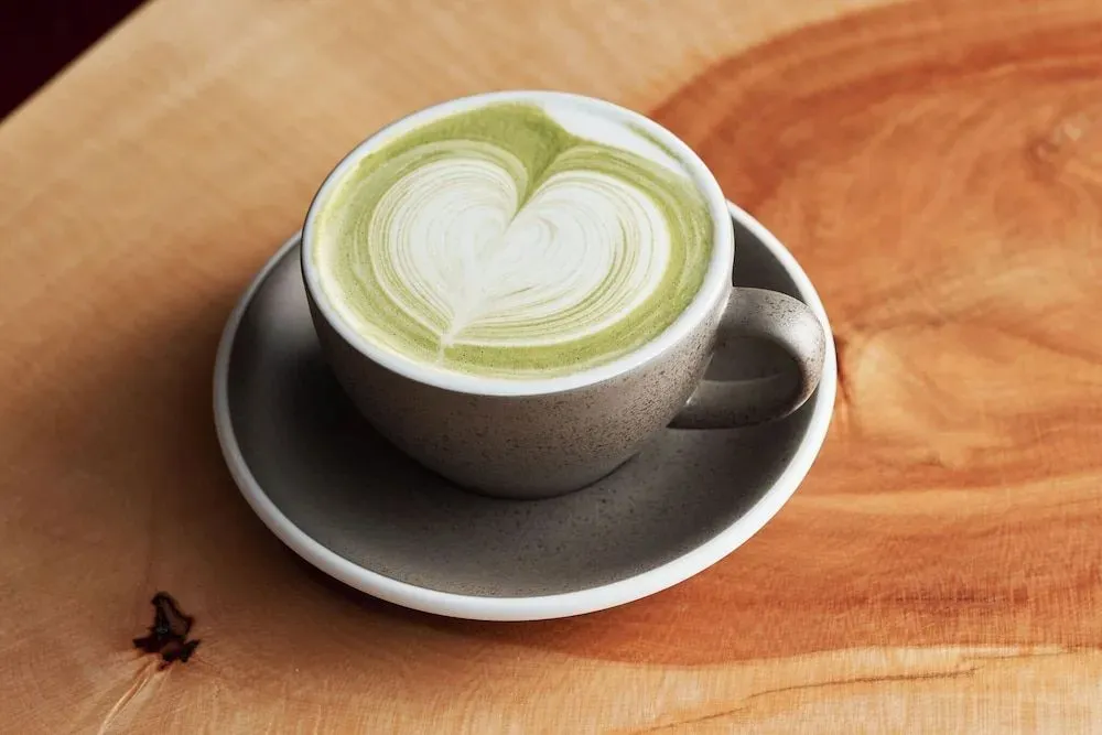 Une tasse de boisson chaude sur une surface en bois.