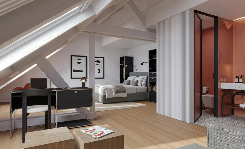 Une chambre mansardée lumineuse avec un espace bureau et une salle de bain moderne.