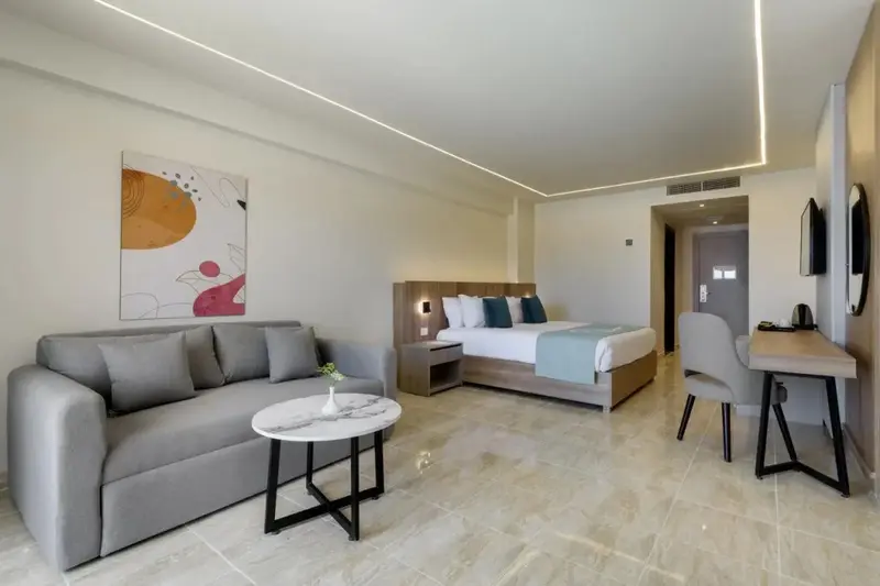 Une chambre lumineuse avec un canapé et un lit double.