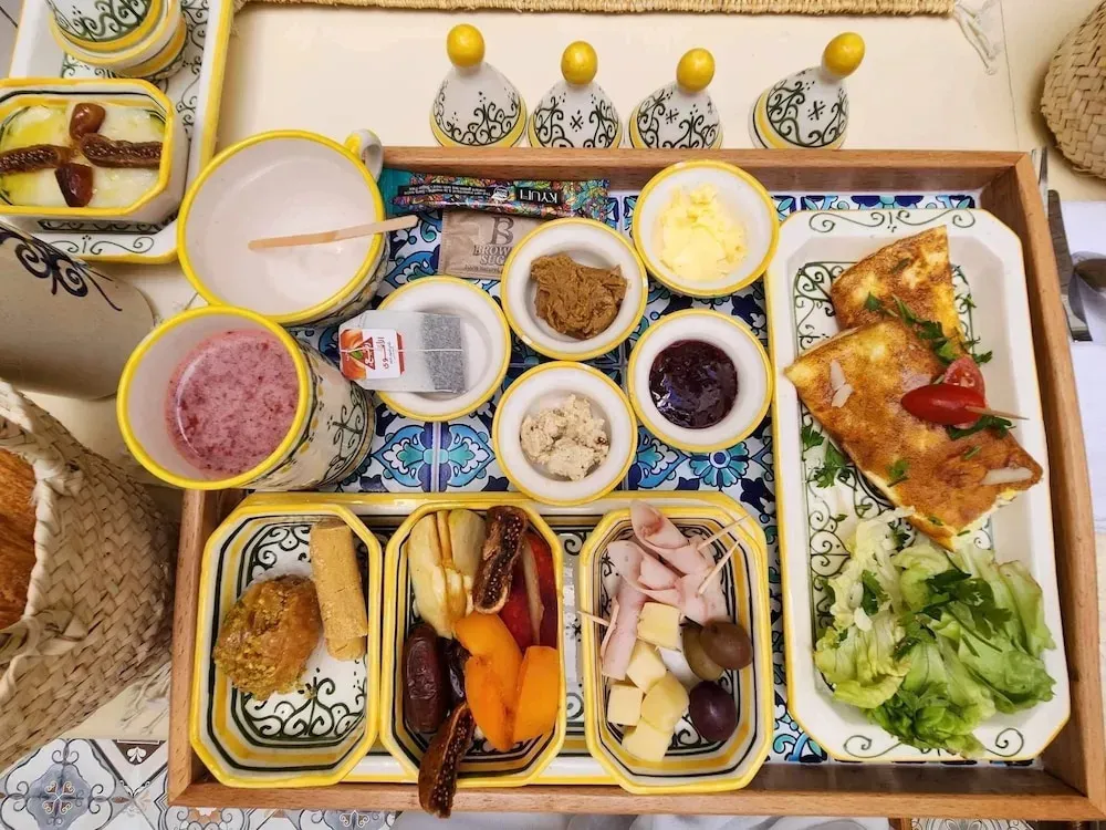 Un plateau de petit-déjeuner copieux est présenté sur une table.