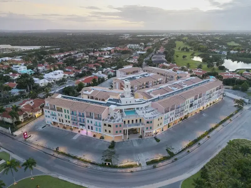 Vue aérienne d'un grand complexe hôtelier aux façades claires et aux nombreux balcons.