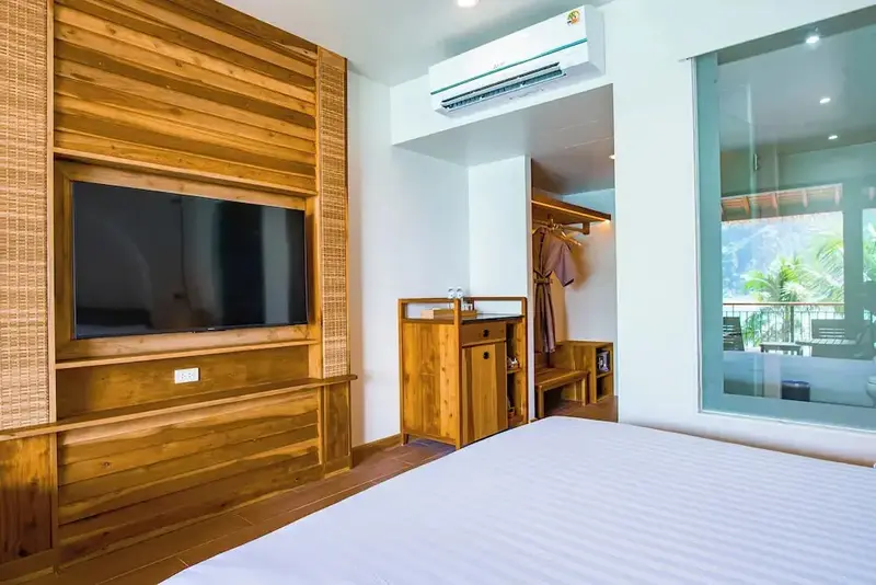 Une chambre lumineuse avec un grand lit et un accès à une terrasse.