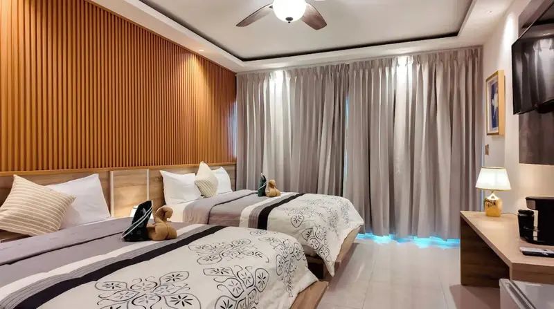 Une chambre lumineuse avec deux lits simples et un décor moderne.