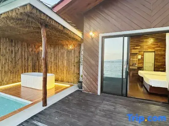 Espace extérieur avec jacuzzi et accès à une chambre lumineuse.