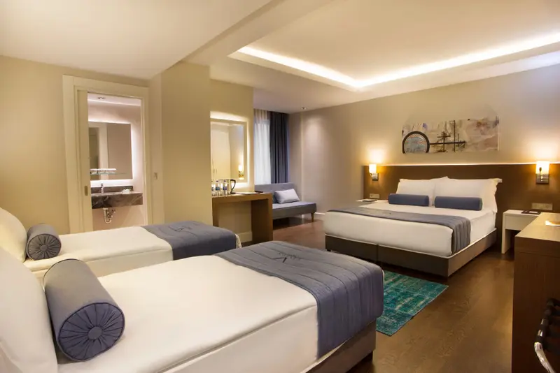 Une chambre spacieuse avec deux lits et un espace salon.