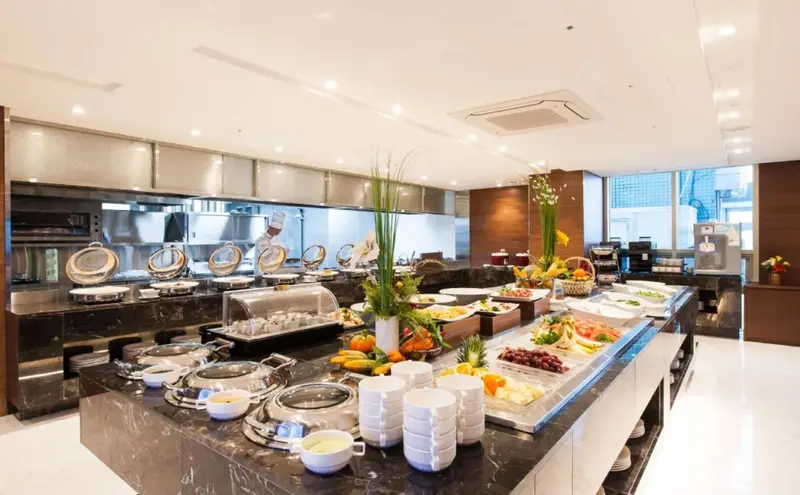Un buffet varié est présenté dans une salle lumineuse et moderne.