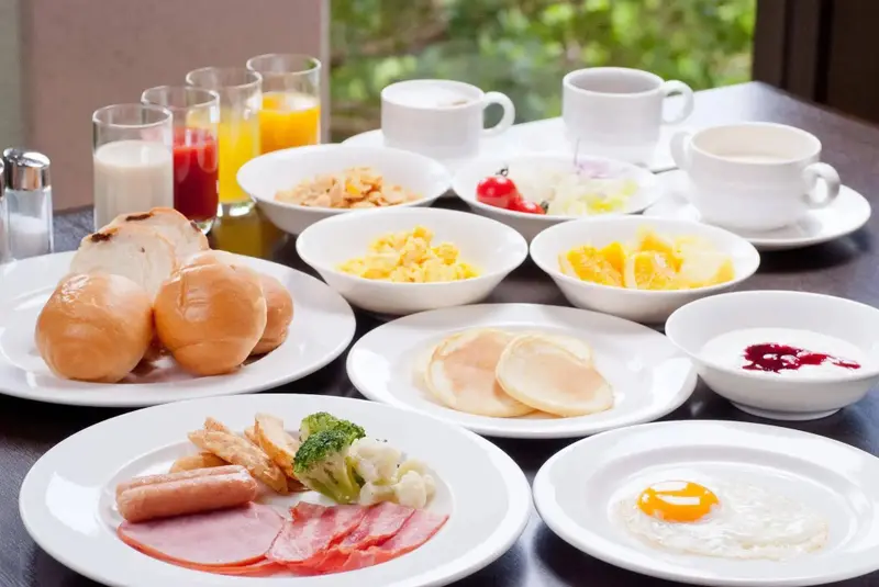 Une table garnie de divers plats pour le petit-déjeuner.