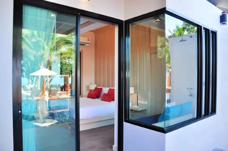Une chambre lumineuse s'ouvre sur une terrasse avec mobilier de jardin.