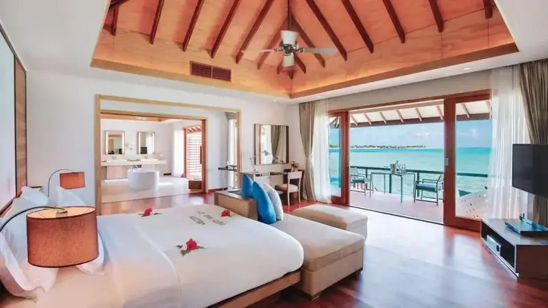Une chambre lumineuse s'ouvre sur une terrasse avec vue sur la mer.