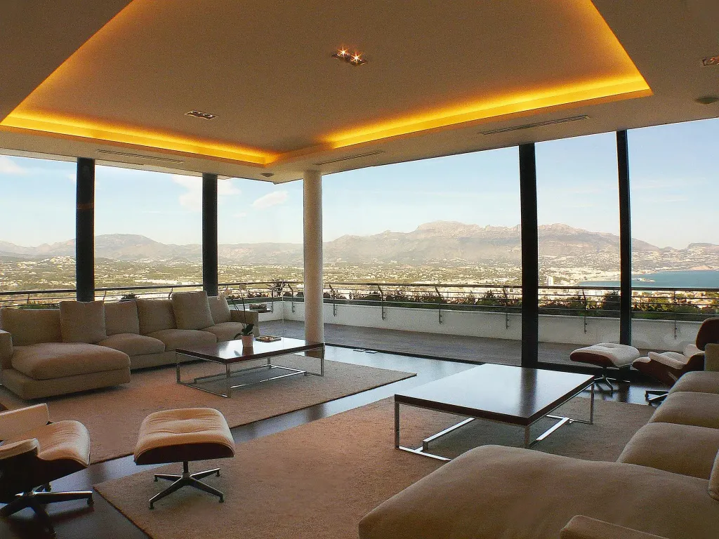 Un espace de détente lumineux offre une vue panoramique sur la ville et les montagnes.