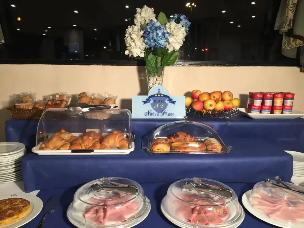 Un buffet propose des viennoiseries, des fruits et des confitures.