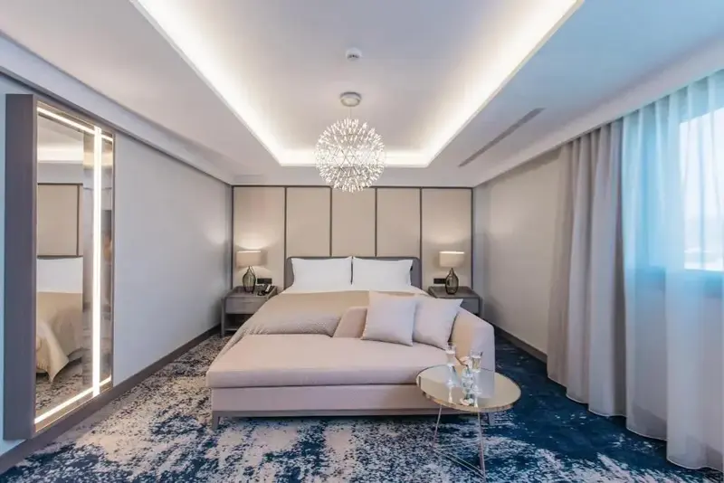 Une chambre lumineuse avec un grand lit et un canapé.