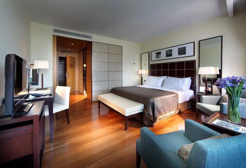Une chambre spacieuse avec un grand lit et un coin salon.
