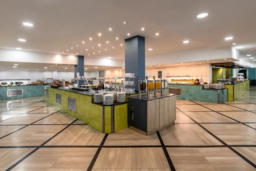 Un buffet bien garni est présenté dans une salle lumineuse et spacieuse.