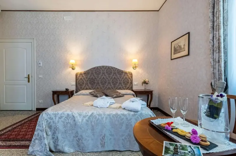 Une chambre lumineuse avec un grand lit recouvert d'une courtepointe et de coussins.