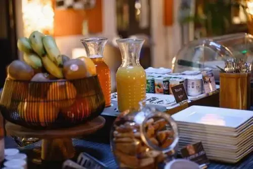 Un buffet propose des fruits frais, des jus et des céréales.