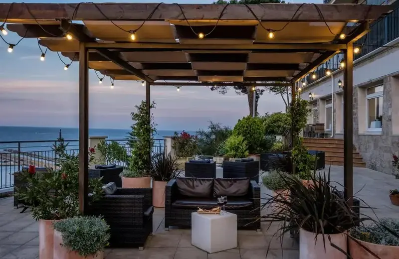 Espace de détente extérieur avec mobilier confortable et vue sur la mer.