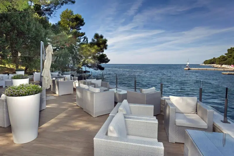 Aménagements extérieurs avec mobilier de détente face à la mer.