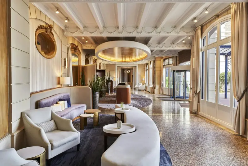 Un espace de réception lumineux avec des canapés et des fauteuils confortables.