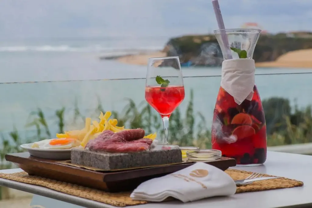Un repas est servi sur une table avec vue sur la mer.