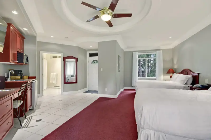 Une chambre spacieuse avec une kitchenette et un accès à une salle de bain.