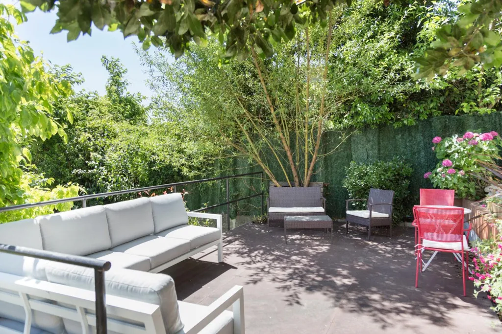 Espace extérieur aménagé avec canapés et tables basses.