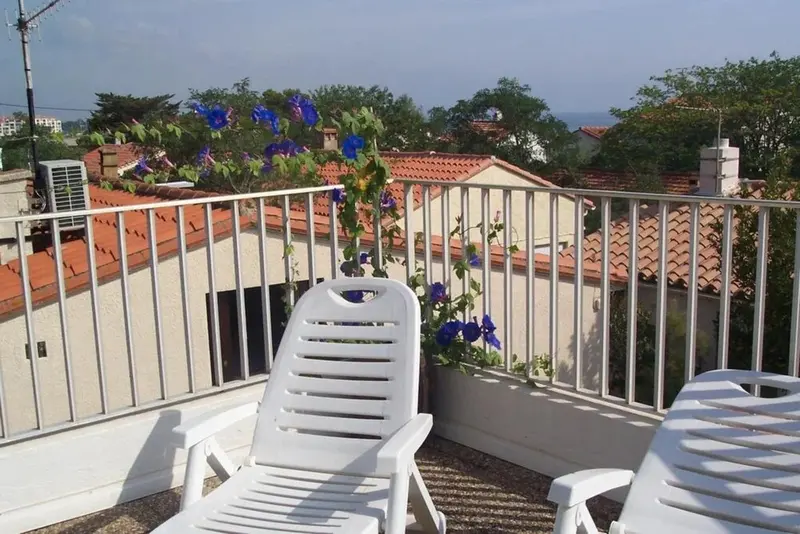 Terrasse avec mobilier d'extérieur et vue sur les toits.
