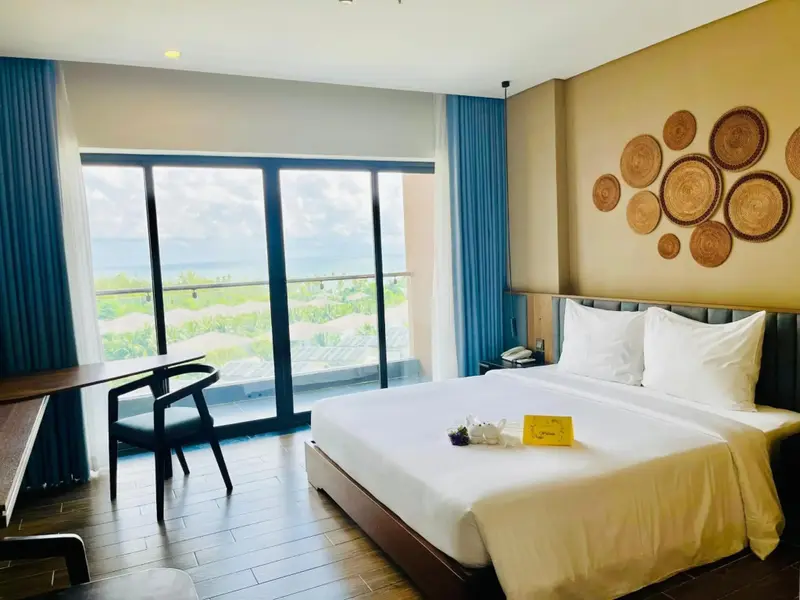 Une chambre lumineuse avec un grand lit et une vue sur un paysage verdoyant.