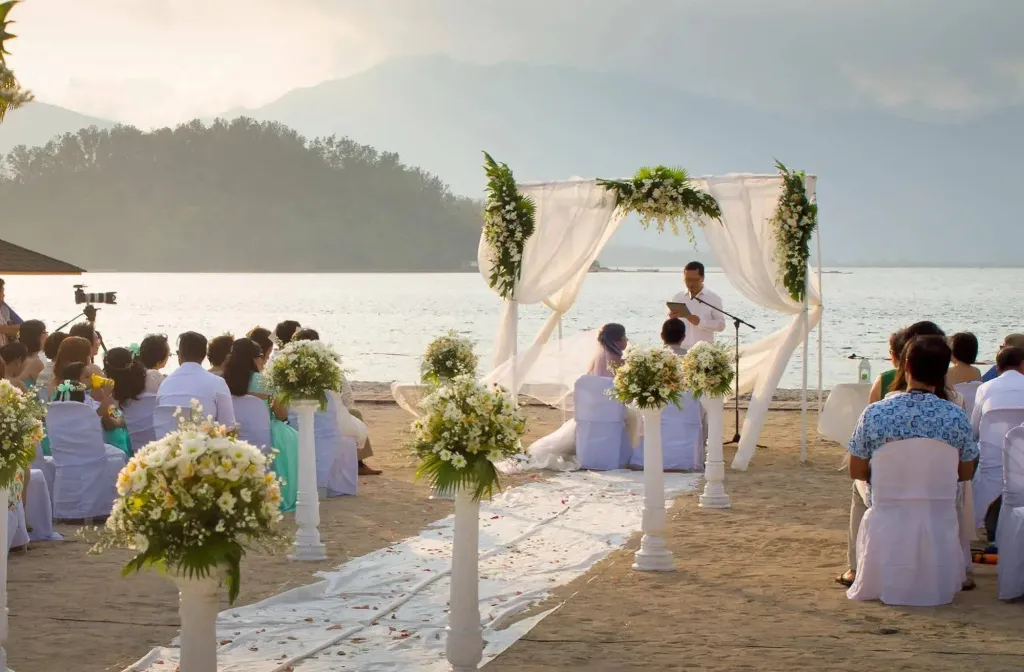Cérémonie de mariage en plein air sur une plage de sable fin, face à la mer.