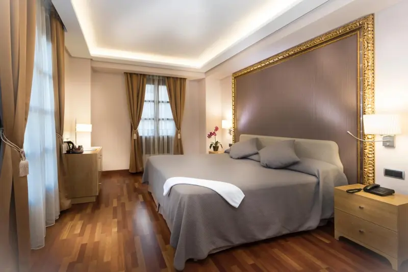Une chambre lumineuse avec un grand lit et une décoration soignée.