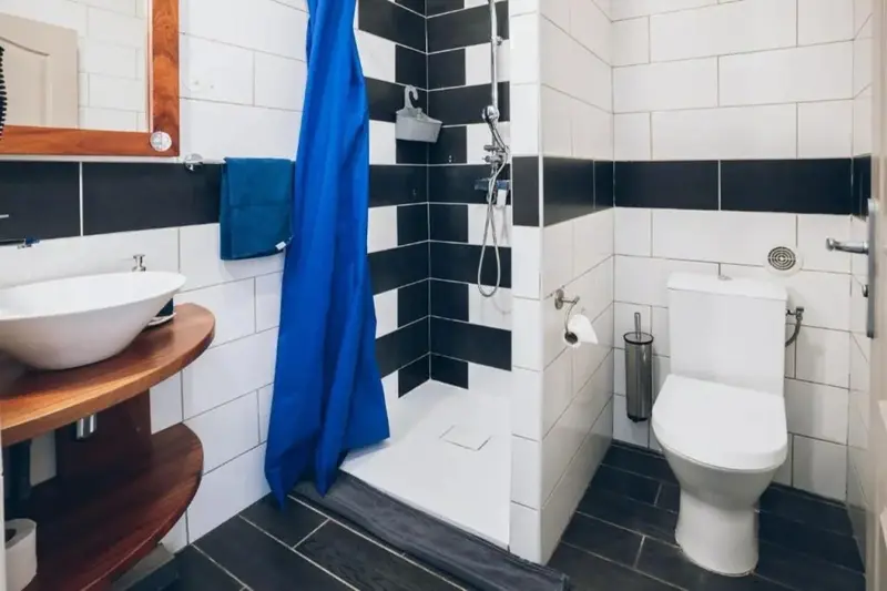 Une salle de bain moderne avec douche à l'italienne et lavabo sur meuble.