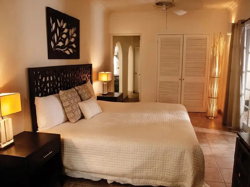 Une chambre lumineuse avec un grand lit et une décoration soignée.