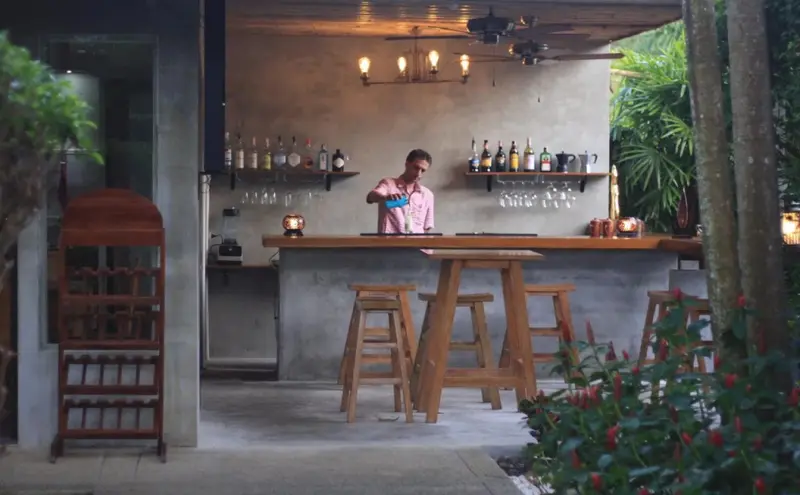 Un bar en plein air propose des boissons rafraîchissantes dans un cadre verdoyant.
