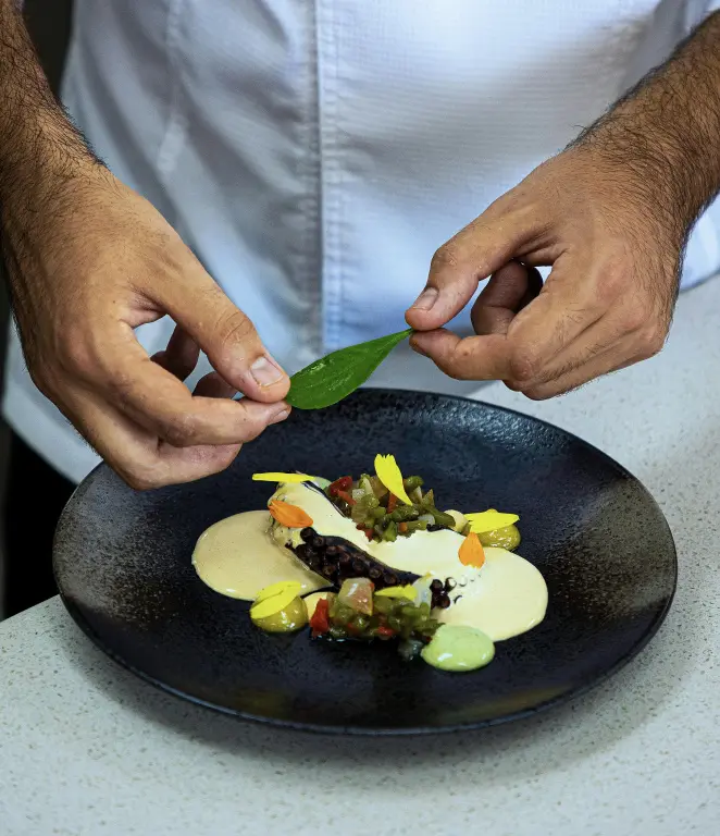 Préparation d'un plat raffiné avec une décoration soignée.