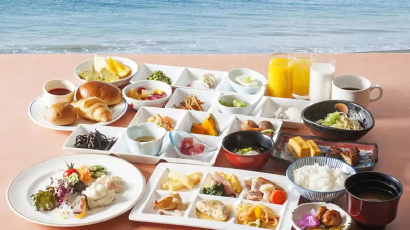 Un copieux petit-déjeuner est présenté sur une table avec vue sur la mer.