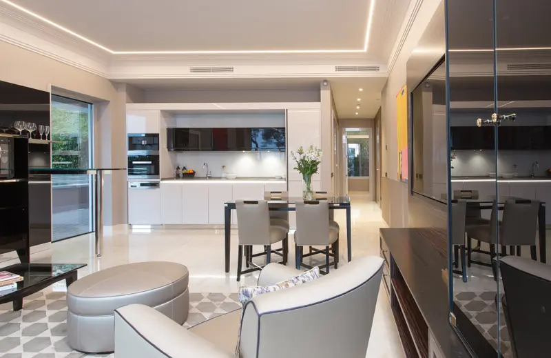 Espace de vie lumineux avec cuisine équipée et table à manger.
