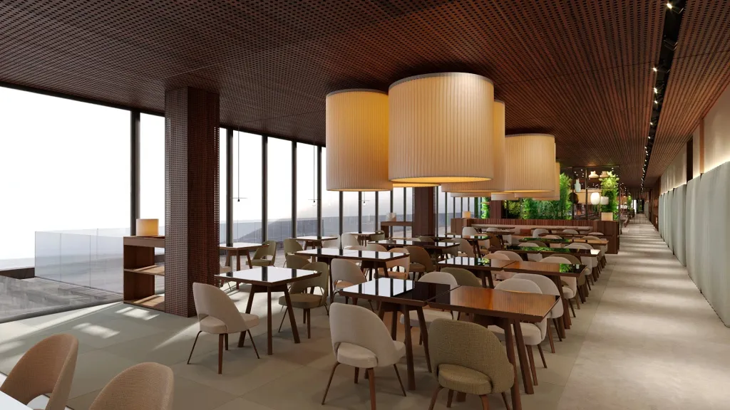 Une salle lumineuse avec de grandes baies vitrées offre une vue dégagée sur le paysage.