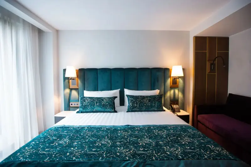 Un lit double est dispose dans une chambre aux tons bleus et blancs.