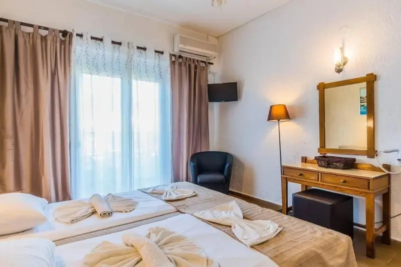 Une chambre lumineuse avec deux lits simples et un coin lecture.