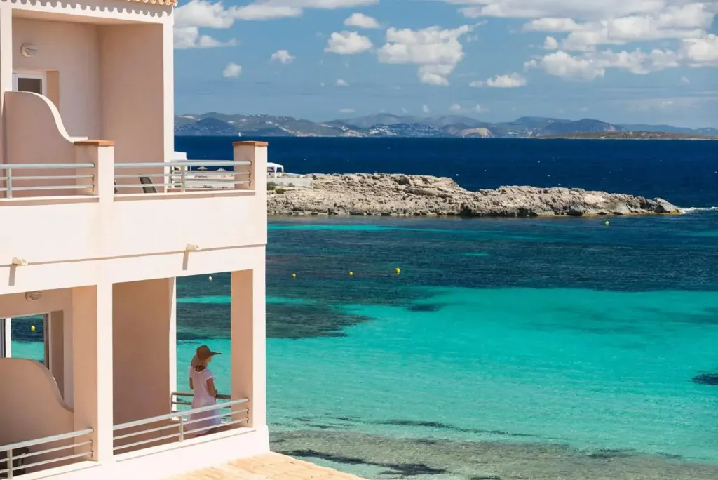 Vue sur la mer turquoise depuis une terrasse d'habitation.