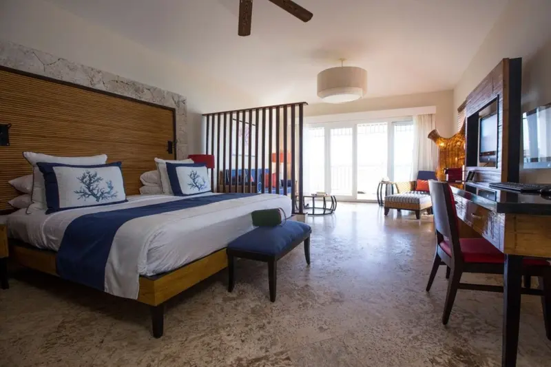 Une chambre lumineuse avec un grand lit et un espace détente.