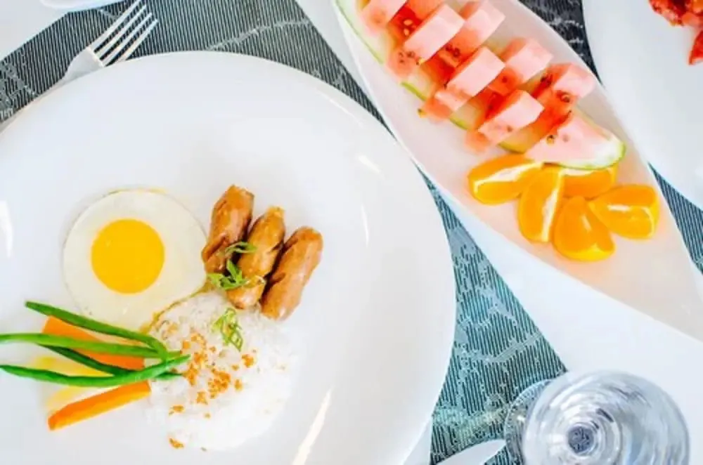 Assiettes de nourriture colorée présentées sur une table.